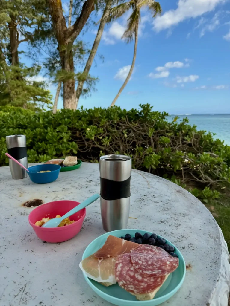 Breakfast table with coffee and ocean view at a beachfront condo on Oʻahu’s North Shore, Hawaiʻi.
